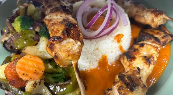 Grilled chicken skewers with vegetables served at TimeOut Restaurant