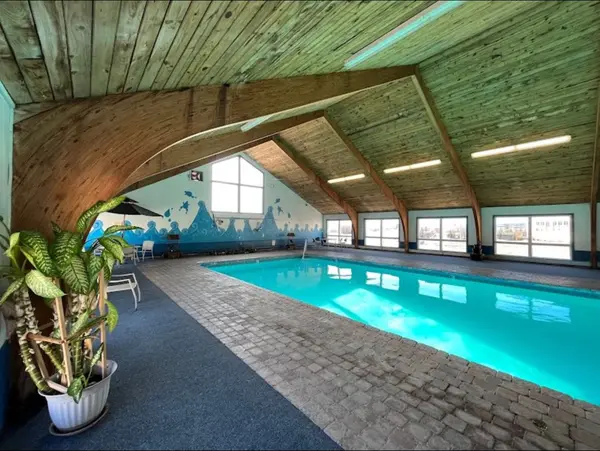 Indoor heated pool — poolside view with tropical plants at Presque Isle Hotel