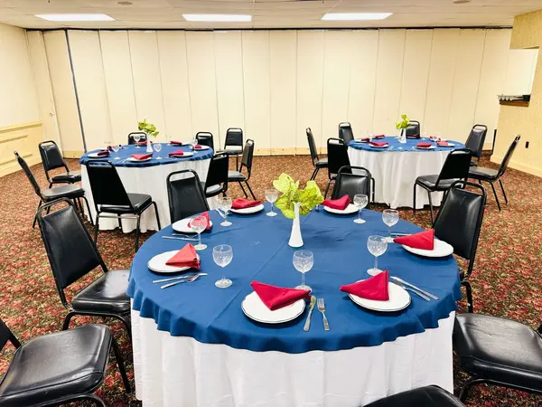 Convention center banquet tables set for a formal dinner at Presque Isle Hotel